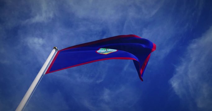Guam flag flying in the wind on flagpole. Guamanian emblem in the sky shows pride - 3d video animation