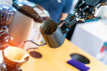 robotic arm preparing coffee in coffee machine