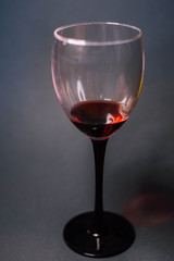 Glass of red wine on a dark background