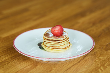 A pile of small pancakes on a plate