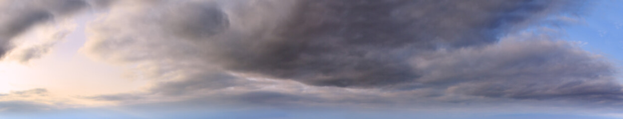 Summer evening sky panorama with clouds background.
