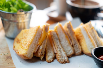 Triangle toast bread with ham and cheese.