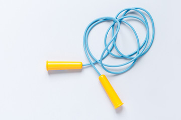 sports composition. jump rope blue with yellow handles on a blue background with a place to write