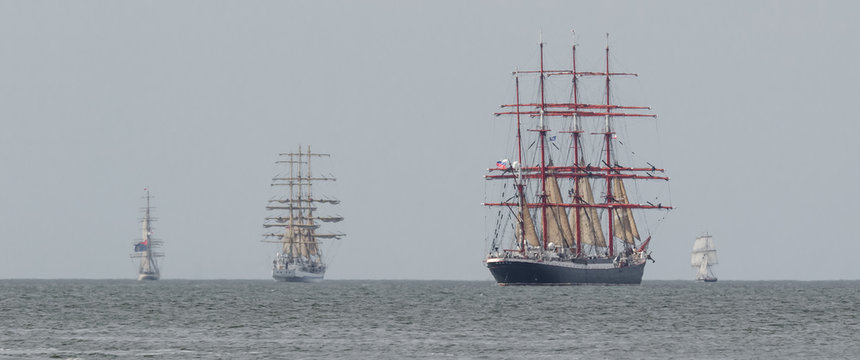 SWINOUJSCIE, WEST POMERANIAN / POLAND - 2017: The Russian sailing ship CEDOV, frigate MIR and RNOV SHABAB OMAN flows on the maritime waterway
