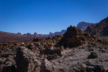 Volcanic rocks in the hills of Tenerife with clear blue skies