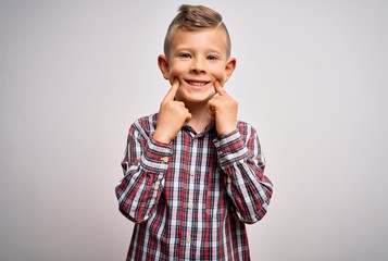 Young little caucasian kid with blue eyes wearing elegant shirt standing over isolated background Smiling with open mouth, fingers pointing and forcing cheerful smile