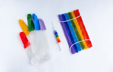 the medical mask, syringe, and glove are painted in rainbow colors. the concept of fighting the virus