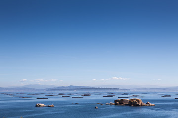 Obraz premium Stunning views of the oyster farms of Galicia Spain on a calm sunny day