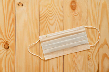 Typical 3-ply surgical mask cover mouth nose. wood