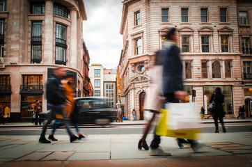 Motion blurred high street shoppers