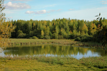 View of the river, forest and blue autumn sky