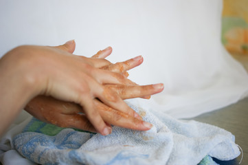 Woman doing hand peeling at home close-up