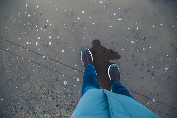 Fototapeta premium female feet in the puddle top view