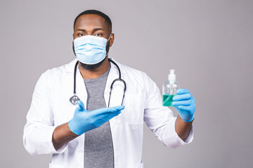 African american doctor man in gown face mask gloves isolated on grey background. Epidemic pandemic...