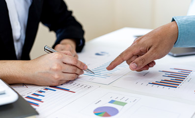 Businessman and financial team are analyzing the results of operations and calculating the company's revenue and expenses in order to prepare for management proposals, Financial  concept.
