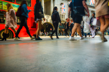 Motion blurred people shoppers on busy street