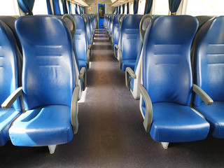 Blue row of seats in the cabin of the train in Europe. Empty train car.