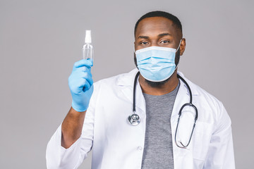 African american doctor man in gown face mask gloves isolated on grey background. Epidemic pandemic...