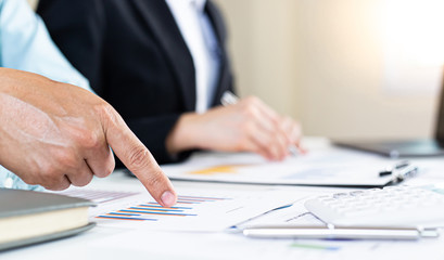 Businessman and financial team are analyzing the results of operations and calculating the company's revenue and expenses in order to prepare for management proposals, Financial  concept.