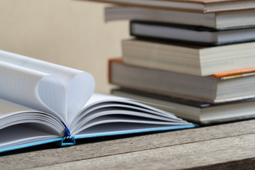 Books and textbook on wooden desk in library, Piles of books on reading desk in school with copy space for text.World book day and education concept.