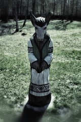 Scary creepy wooden humanoid goat figurine