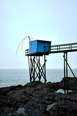 Blue fishing cabin and the sea