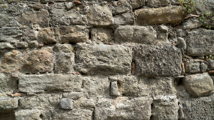 Natural stone wall texture. Medieval masonry. Ancient wall. Stone brick wall. Macro texture. Medieval architecture. Rough masonry. Background texture.