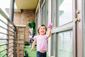 Toddler Girl Running on Balcony