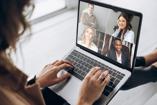 Online business meeting. Business team working from home in a video conference. .The girl communicates via video call communication using laptop with her business colleagues about the future strategy