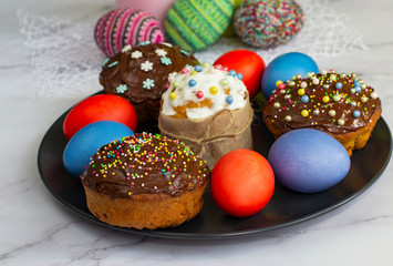 Decorated muffins with chocolate icing and colored eggs