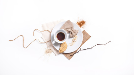 Top view of minimalist breakfast served with coffee, bran, spices, cookie, bright colors