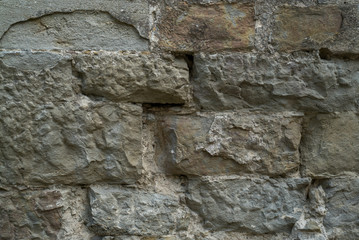 Natural stone wall texture. Medieval masonry. Ancient wall. Stone brick wall. Macro texture. Medieval architecture. Rough masonry. Background texture.