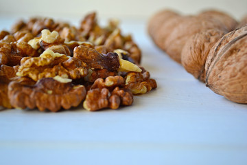 Walnuts on a white wooden background.