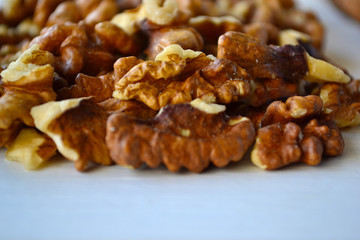 Walnuts on a white wooden background.