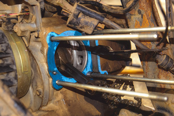 The motorcycle's engine is serviced or repaired by a mechanic.	