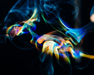 Rainbow colored smoke on a black background