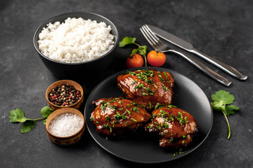 grilled sweet chicken thighs and  cooked rice on a stone background. Asian food