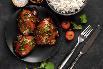 grilled sweet chicken thighs and  cooked rice on a stone background. Asian food