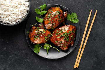 grilled sweet chicken thighs and  cooked rice on a stone background. Asian food