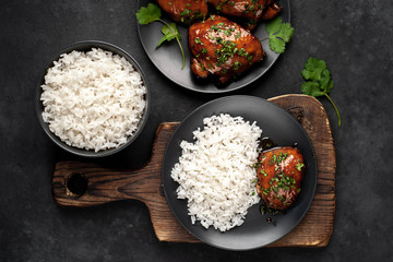 grilled sweet chicken thighs and  cooked rice on a stone background. Asian food