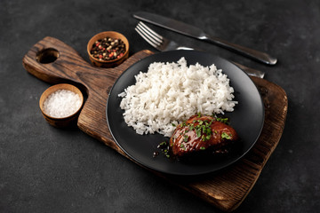 grilled sweet chicken thighs and  cooked rice on a stone background 
. Asian food