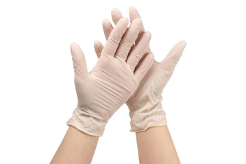 Woman puts on white rubber gloves.