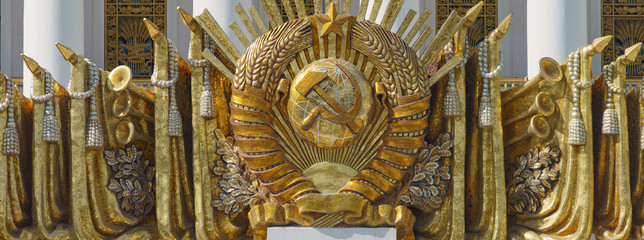 Panoramic photography of the the coat of arms of the Soviet Union on the building. Soviet sign in architecture. Heritage concepts. 