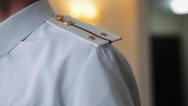 Military epaulettes on a white shirt close-up