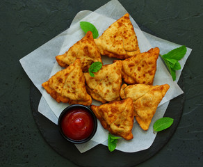 Asian food. Vegetarian samsa (samosas) with tomato sauce