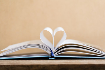 Books and textbook on wooden desk in library, Piles of books on reading desk in school with copy space for text.World book day and education concept.