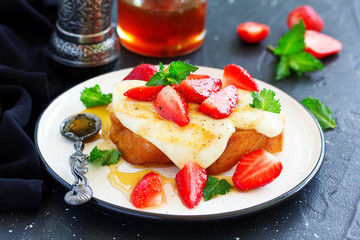 toast with grilled mozzarella, fresh strawberries and honey. Useful zavstrak.