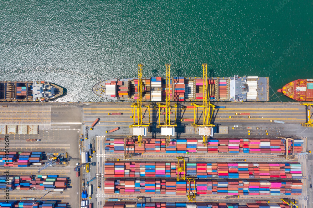 Wall mural Container , container ship in export and import business and logistics. Shipping cargo to harbor by crane. Water transport International. Aerial view and top view.