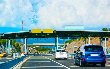 Cars at Toll booth with Blank signs on road Slovenia reflex