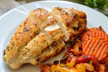 Baked chicken breast with vegetable. Light background. Close up. Meat dish. Food in a white plate. Healthy lunch.